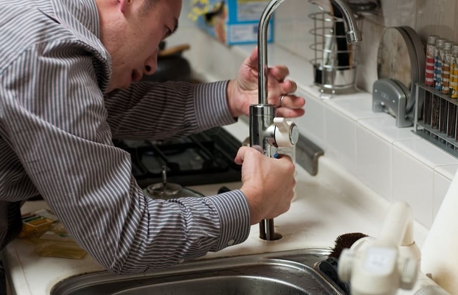 handyman fixing kitchen plumbing emergency