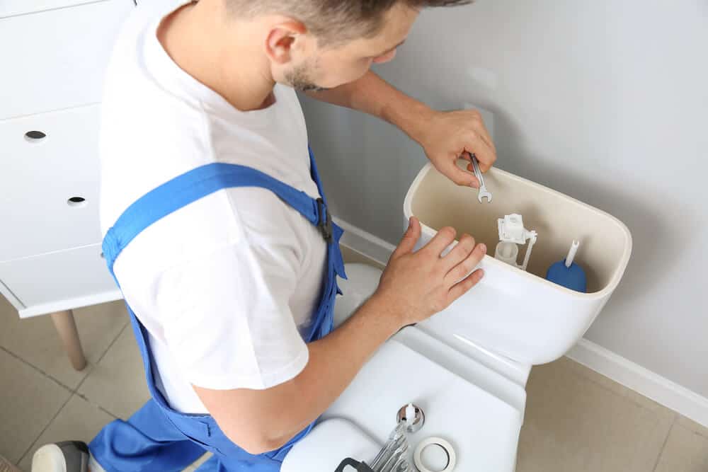 Kenec Plumbing and Gas plumber fixing toilet