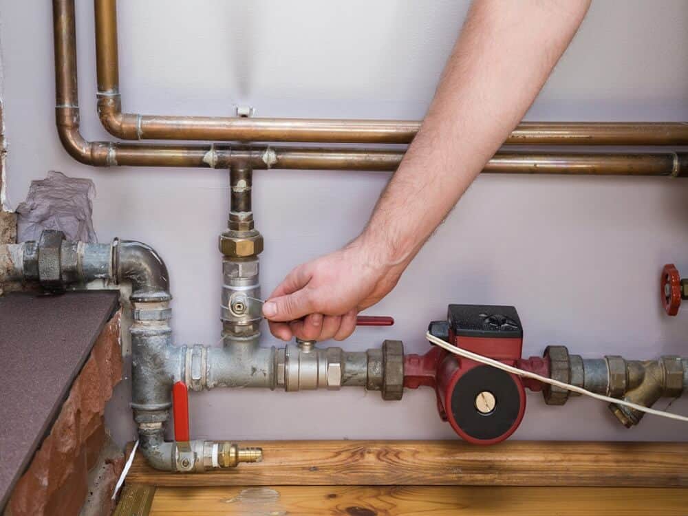 Kenec Plumbing and Gas plumber working the gas fitting valves